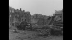 Belgium: ADC-2969 - Bombing of Bastogne; wrecked German equipment; US MP check point; Paratroopers